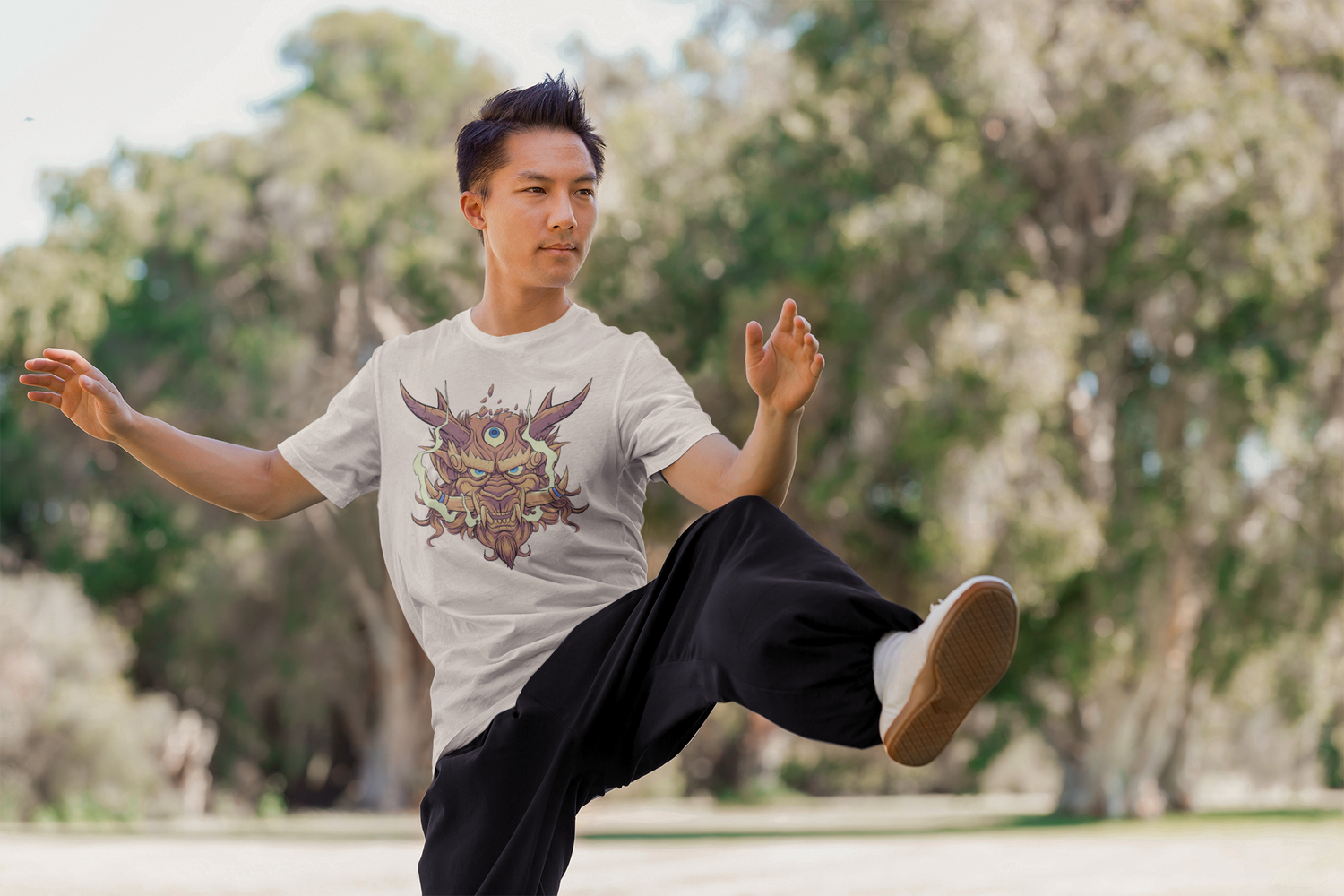 Kung-fu practitioner kicking with oni shirt on